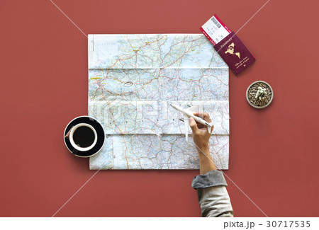 Hand holding toy airplane and planning travel destination Hand holding toy airplane and planning travel destination 30717535