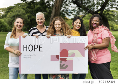 Group of women holding banner of charity donations campaign Group of women holding banner of charity donations campaign 30718584