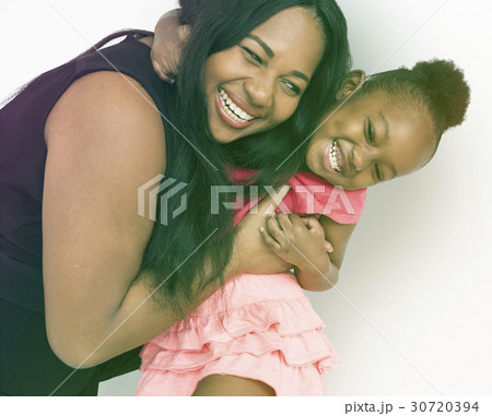African American Mother Daughter Hug Together Studio Portrait 30720394