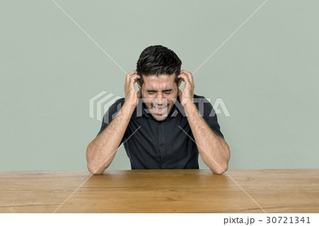 Stress man is sitting at wooden table 30721341