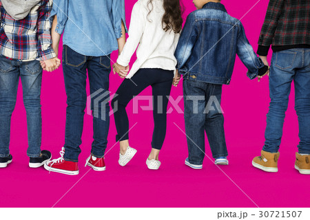 Group of children holding hand together in rear view 30721507