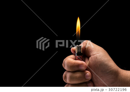 Hand holding burning gas lighter. Studio shot isolated on black background 30722196