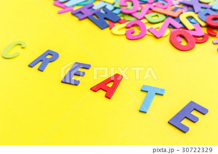 Colorful wooden alphabet and word "CREATE". Top view on yellow table 30722329
