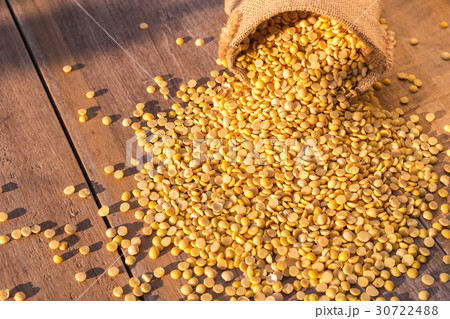 Peeled yellow soybean in small sack on wooden table background 30722488