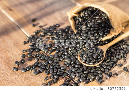 Black bean in small brown sack on wooden table background Black bean in small brown sack on wooden table background 30722591