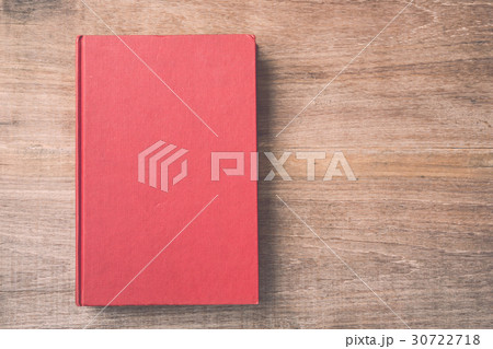 Old book on wooden plank background 30722718