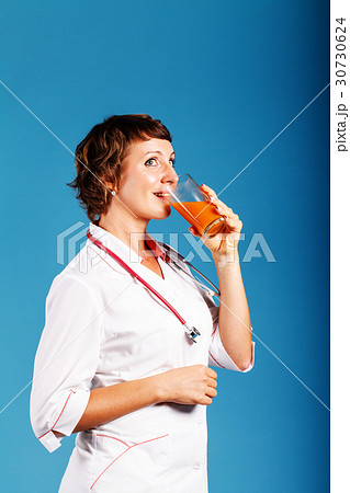 young woman doctor with a glass of fresh juice 30730624