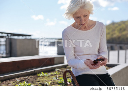Embarrassed woman having high fever in the park Embarrassed woman having high fever in the park 30735118