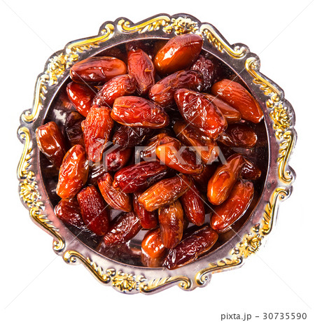 Beautiful Dates fruit on a silver tray isolation  30735590