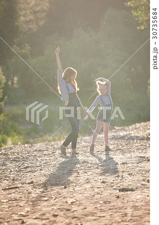 Mother and daughter on a walk Mother and daughter on a walk 30735684