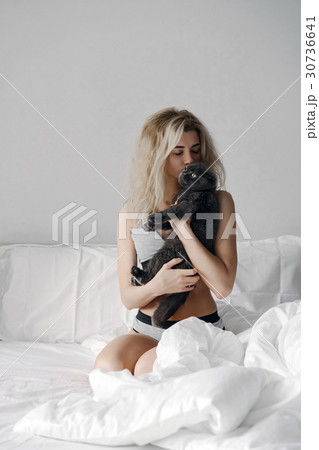 Happy young woman hugging a cat Happy young woman hugging a cat 30736641