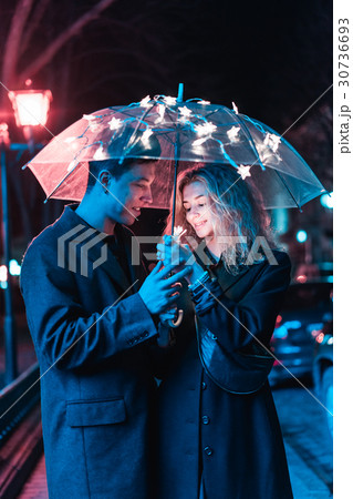 Portrait of a guy and a girl under an umbrella 30736693