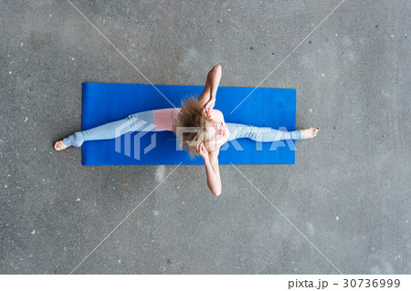 Young slim blond woman making yoga exercises 30736999