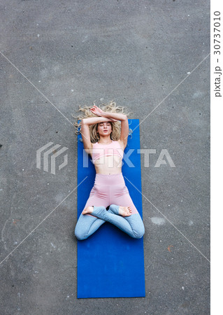 Young slim blond woman making yoga exercises 30737010