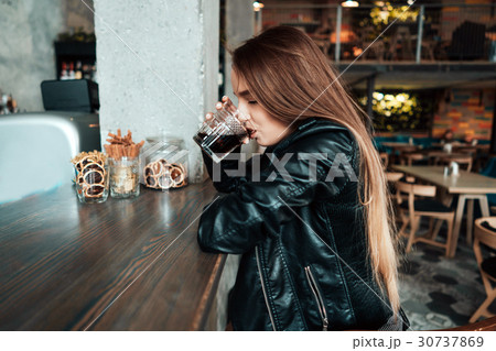 Beautiful girl in a black jacket in a cafe 30737869