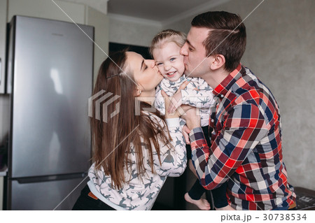 Mom, Dad and little girl having fun together 30738534
