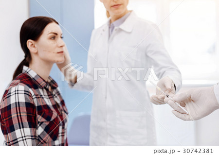 Selective focus of a medical syringe being given 30742381