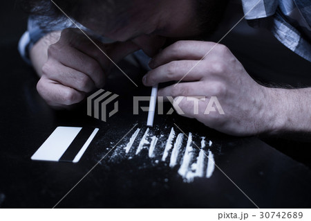 Involved drug addict inhaling cocaine lines in the 30742689