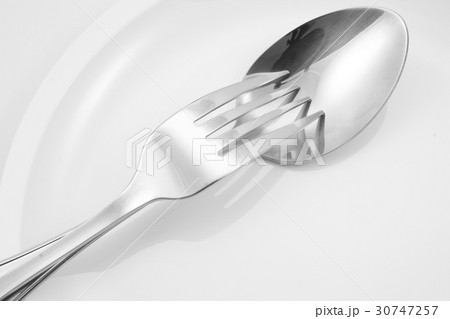 Fork and spoon on a plate with napkin 30747257