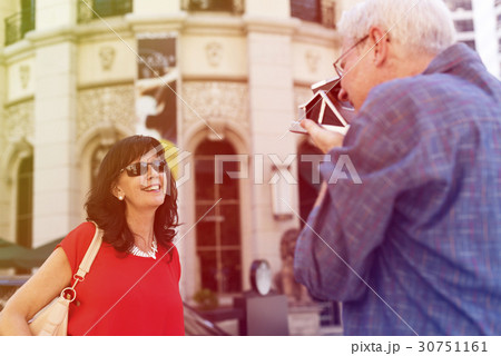 Photo Gradient Style with Old guy taking a photo of his wife city background 30751161