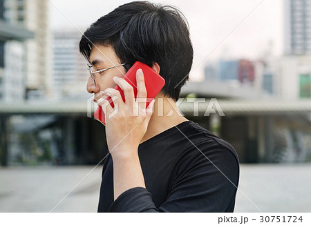 Asian man talking on mobile phone communication 30751724