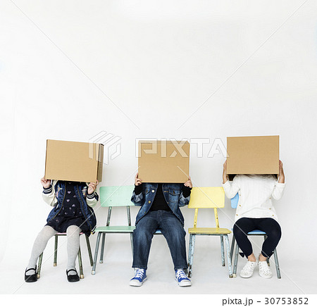 Group of children are playing paper box game. 30753852