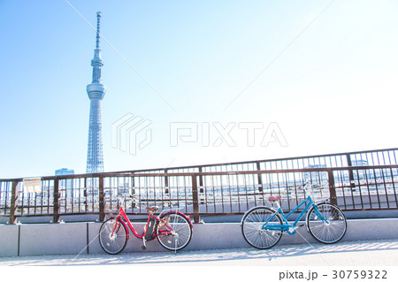 Red Bicycle park at railing of the bridge on road 30759322