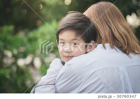 asian mother hugging with her son in the park asian mother hugging with her son in the park 30760347