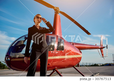 Business woman near the helicopter Business woman near the helicopter 30767513