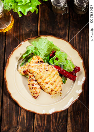 Grilled chicken breasts served with grilled paprika 30768987