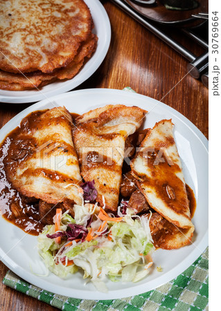 Potato pancakes with meat stew served Potato pancakes with meat stew served 30769664
