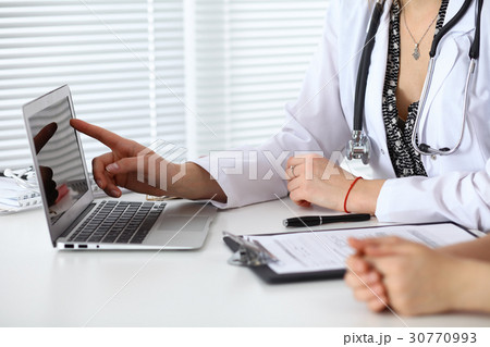 Close-up of a doctor and patient sitting at the 30770993