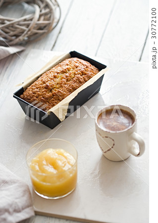 Glazed applesauce oatmeal bread on a white marble  30772100