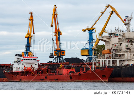 Red cargo ship loading 30773443