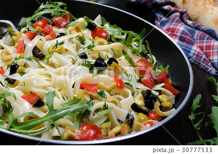 Pasta with olives and tomatoes 30777533