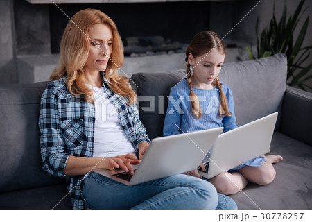 Apathetic mother and little daughter surfing the Apathetic mother and little daughter surfing the 30778257