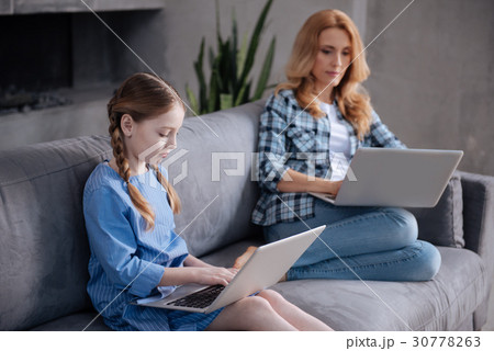 Addicted little child using gadget with mother Addicted little child using gadget with mother 30778263
