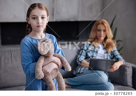 Sad little child waiting for busy parent attention 30778265