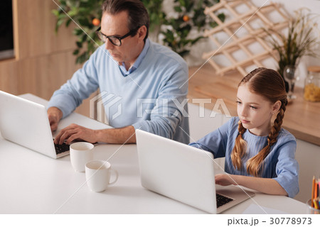 Retired man and little girl surfing the Internet 30778973