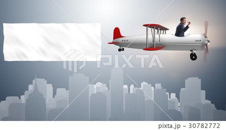 Biplane with businessman and blank banner 30782772