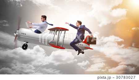 Businessman flying on vintage old airplane Businessman flying on vintage old airplane 30783027