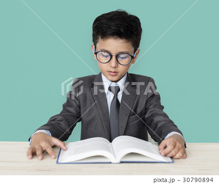A Caucasian Boy With Glasses Reading Book Background Studio Portrait 30790894