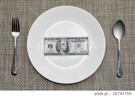 one hundred dollar bill on plate to be eaten 30792760