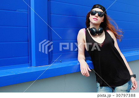 Cute girl hipster in a light hat and sunglasses 30797388