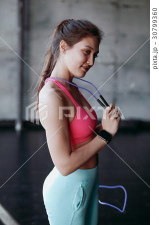 beautiful woman with skipping rope in the gym 30799360