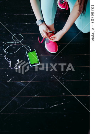 Runner woman tying running shoes laces Runner woman tying running shoes laces 30799731