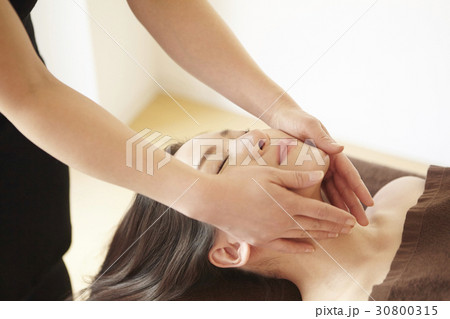 A woman is getting a face massage in spa. 30800315