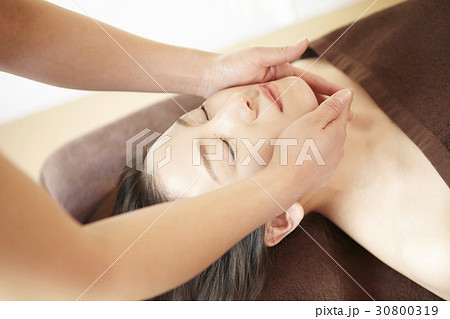A woman gets a facial massage in spa. A woman gets a facial massage in spa. 30800319