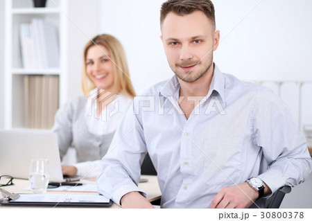 Two successful business partners working at 30800378