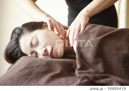 A woman is massaged her neck in spa. 30800419